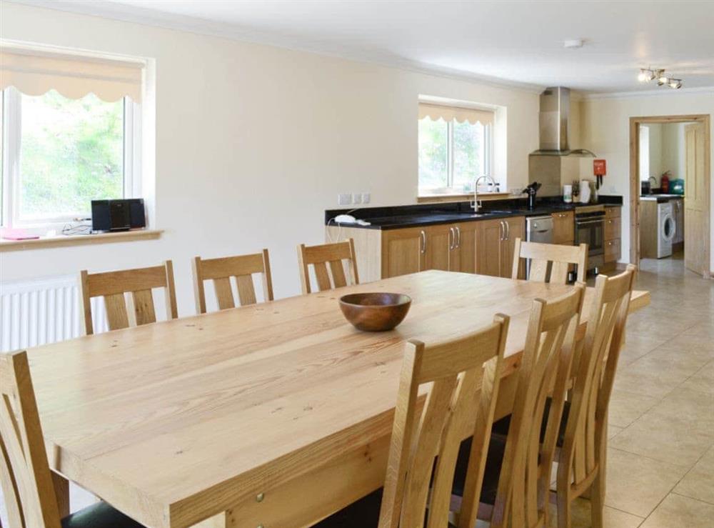 Large open plan kitchen and dining room has French windows that open out to the grounds at March Cottage in Glen Cassley, near Lairg, Sutherland