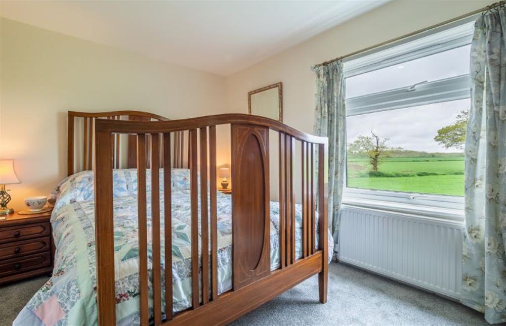 First floor: Master bedroom with double bed and lovely country views at Margarets Cottage, Potter Heigham near Great Yarmouth