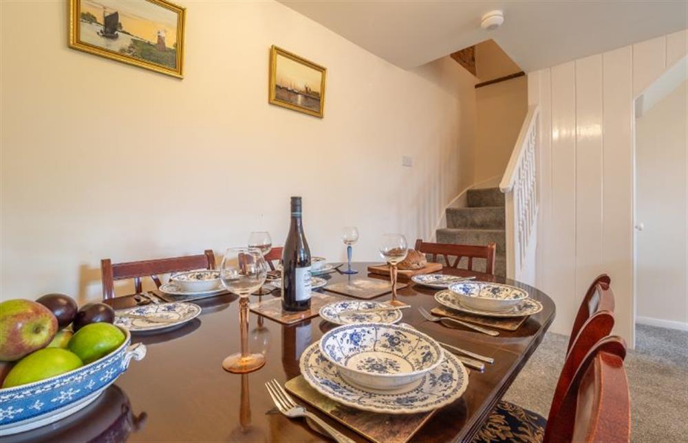 Ground floor: Dining table with stairs to the first floor at Margarets Cottage, Potter Heigham near Great Yarmouth