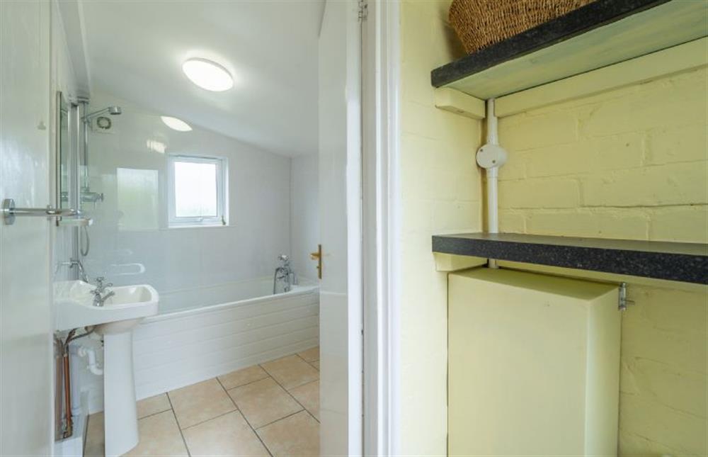 Ground floor: From lobby in to the family bathroom with a bath and shower over, wash basin and WC at Margarets Cottage, Potter Heigham near Great Yarmouth