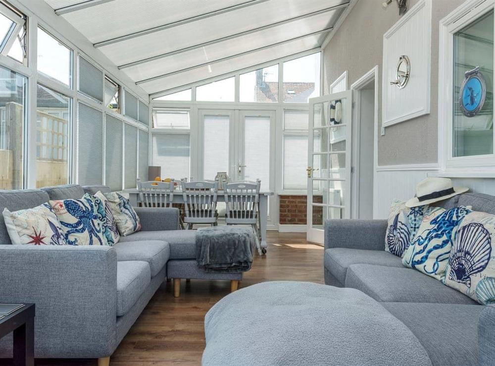 Impressive conservatory with French doors leading to garden (photo 2) at Marian’s Seaside Cottage in Overstrand, Cromer, Norfolk