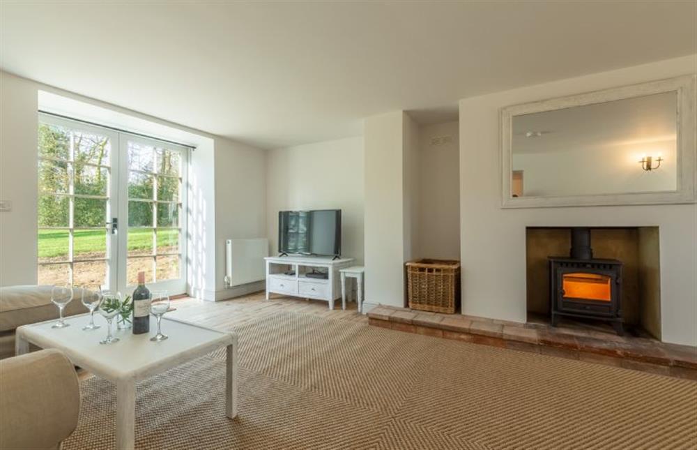 First floor: The large sitting room has a cosy fire for cooler evenings at Market Square House, Fring near Kings Lynn