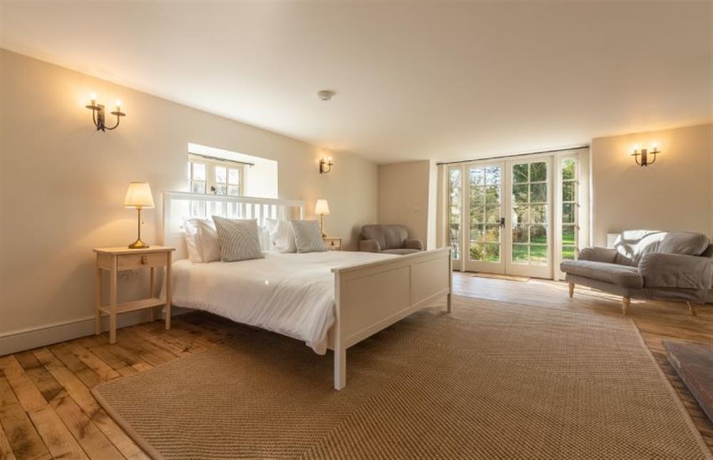 Ground floor: Master bedroom With Super King size bed and french doors onto the garden at Market Square House, Fring near Kings Lynn