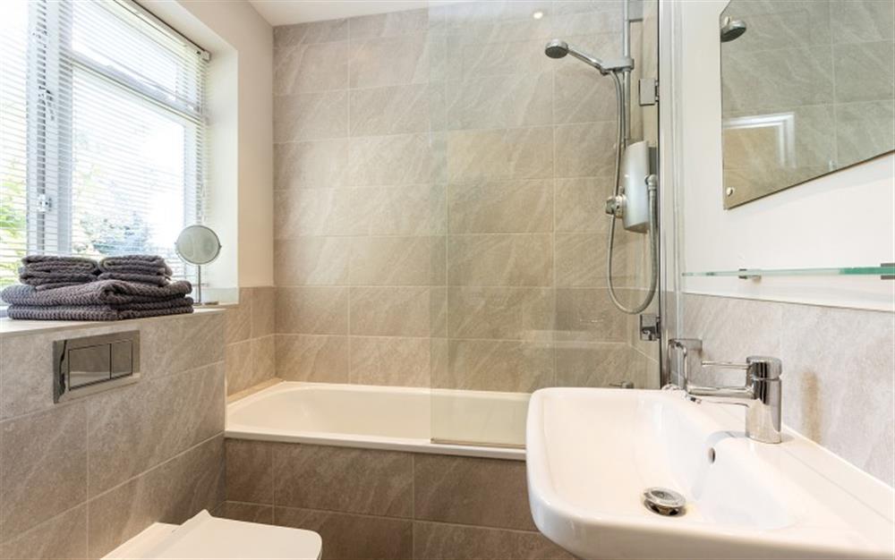 Ground floor family bathroom with shower over bath at Marquis of Lorne Cottage in Bridport