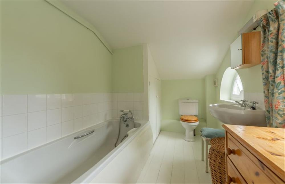 En-suite bathroom has hand-held shower at Marram Cottage, Brancaster Staithe near Kings Lynn