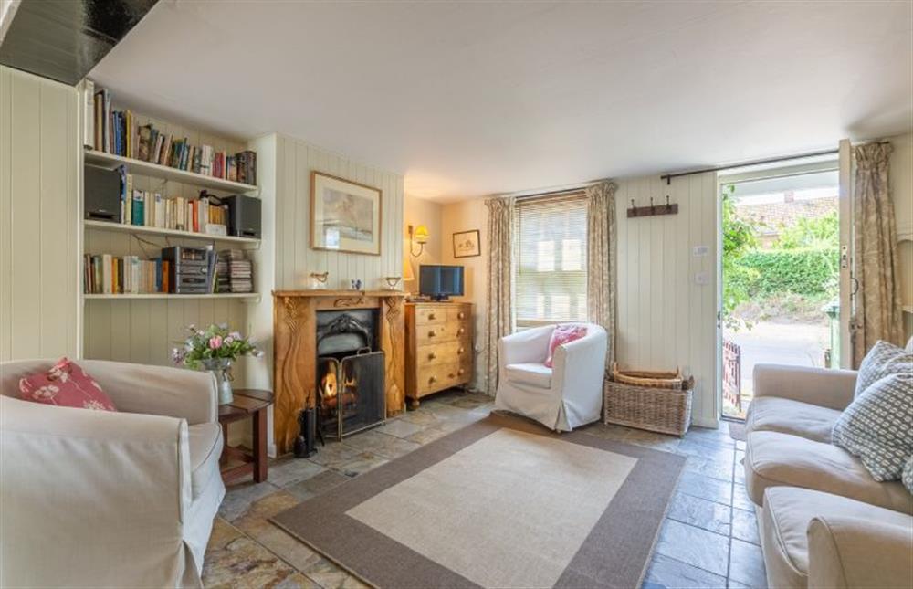 The bright Sitting room has an open fire at Marram Cottage, Brancaster Staithe near Kings Lynn