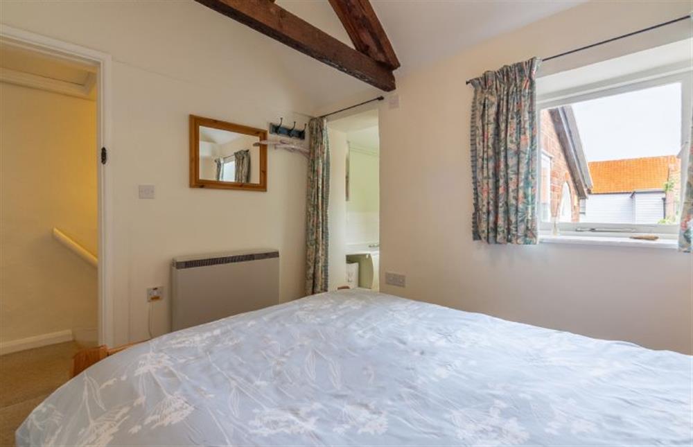 The Master bedroom has a double bed and en-suite bathroom at Marram Cottage, Brancaster Staithe near Kings Lynn