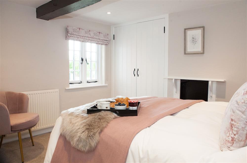 Finch bedroom with a 4’6 double bed and en-suite shower room at Marrington Farmhouse, Montgomery