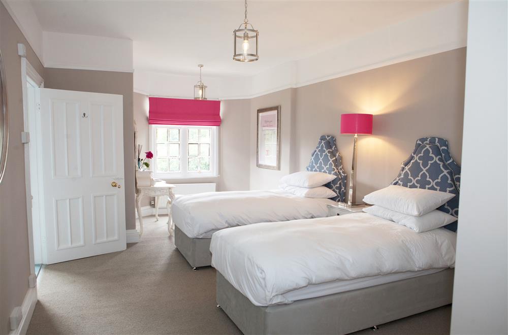 Chanel bedroom with a 6’ super-king size bed and en-suite shower room at Marrington Hall, Montgomery