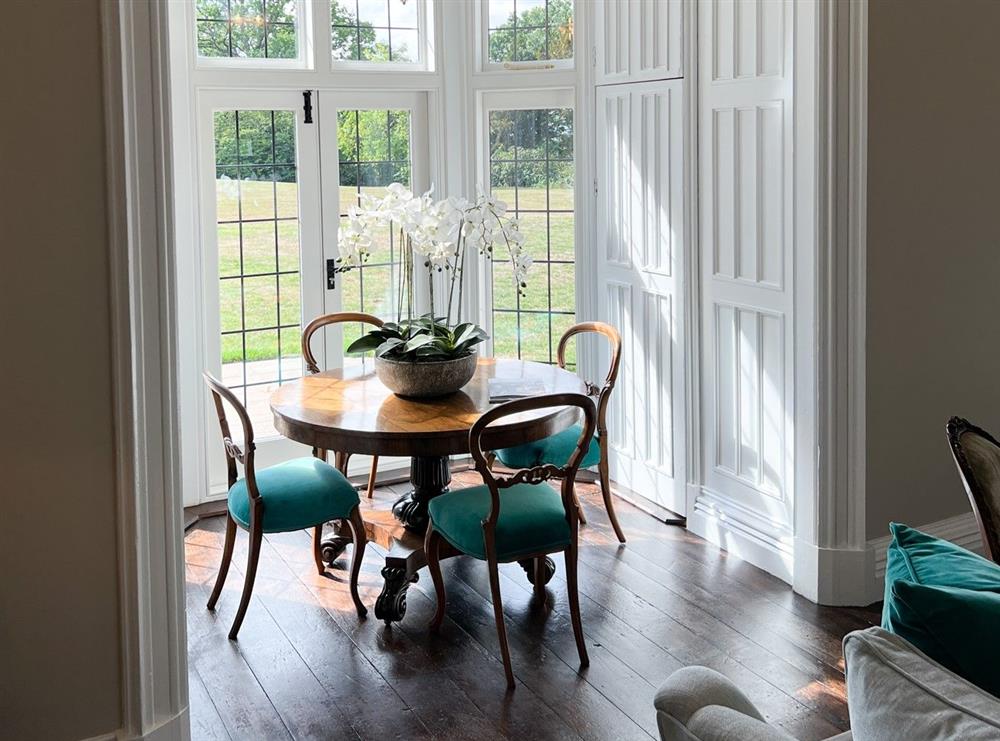 Drawing room with breakfast table overlooking the garden at Marrington Hall, Montgomery