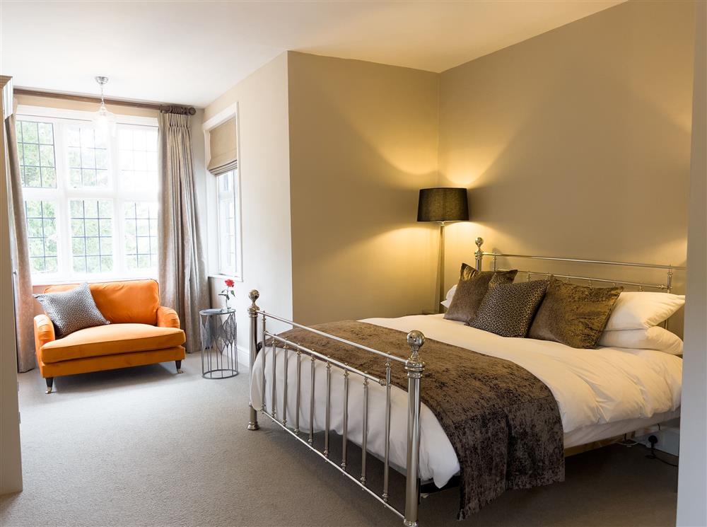 Saffron bedroom with a 6’ super-king size bed and Smart television at Marrington Hall, Montgomery