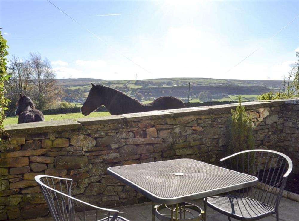 Patio with furniture and countryside views at Marsh Cottage in Oxenhope, near Haworth, West Yorkshire