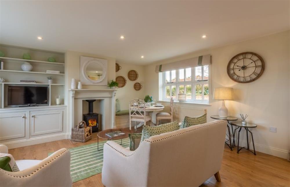Ground floor: Cosy up in front of the fire after long walks at Marsh Retreat, Brancaster near Kings Lynn