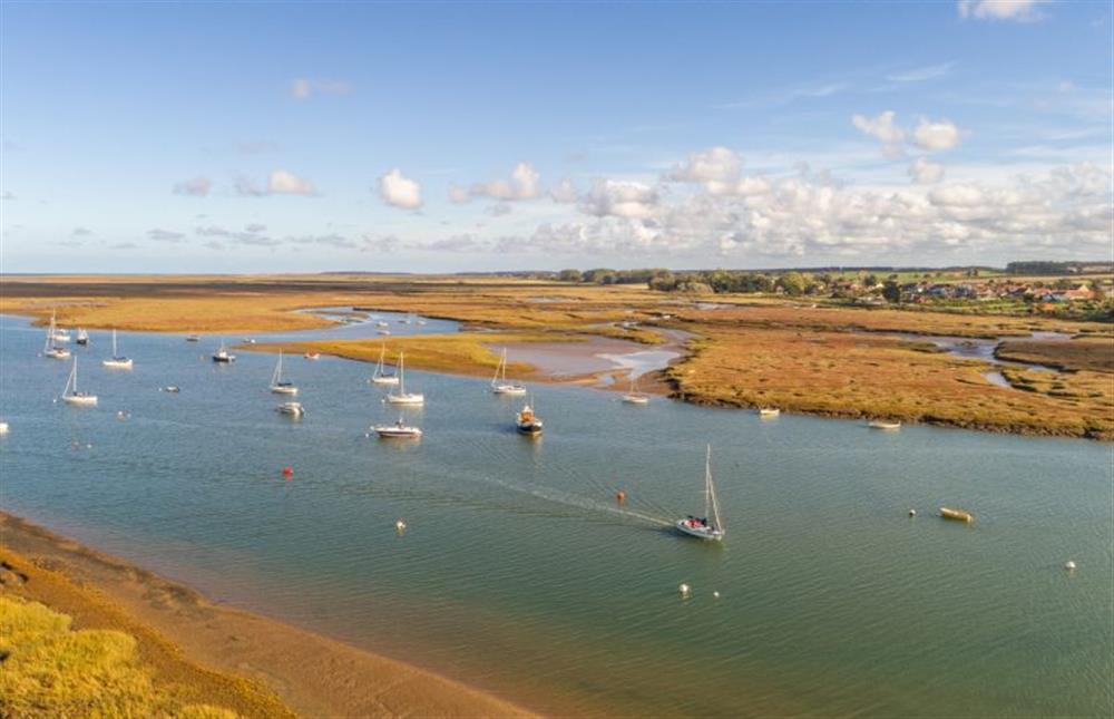 Looking over the salt marsh and creeks to The Norfolk Coast Path at Marsh Retreat, Brancaster near Kings Lynn