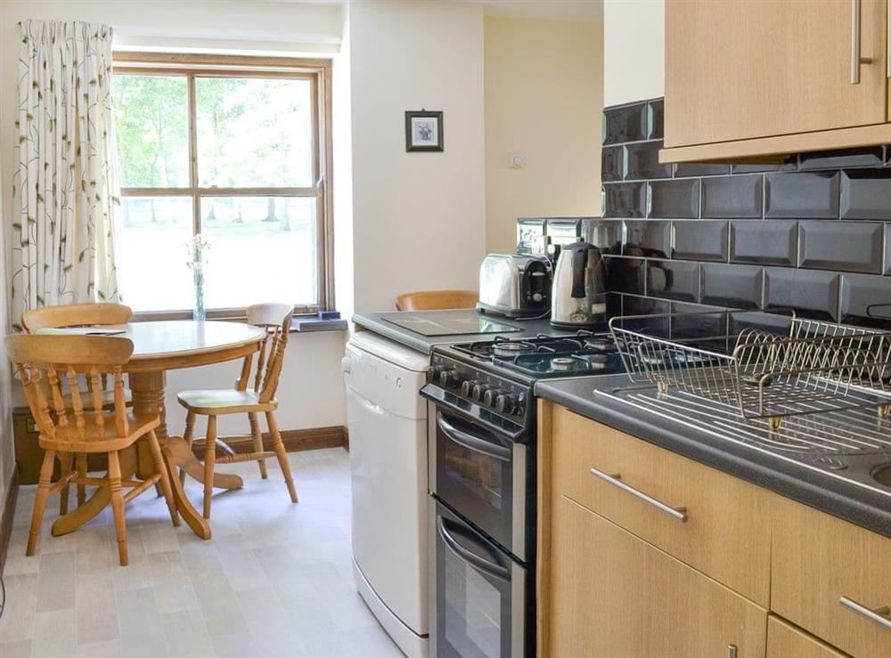 Well-equipped kitchen and convenient dining area at Clydesdale Cottage, 