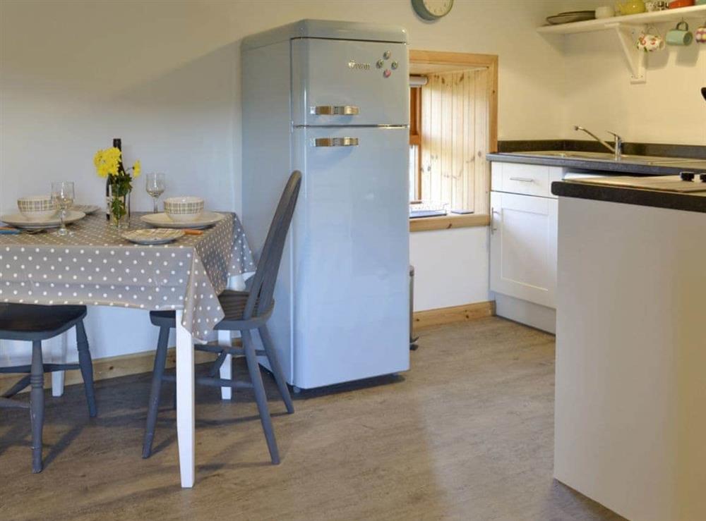 Well-equipped kitchen with dining area at Marys Cottage in Clachan, Staffin, Isle Of Skye