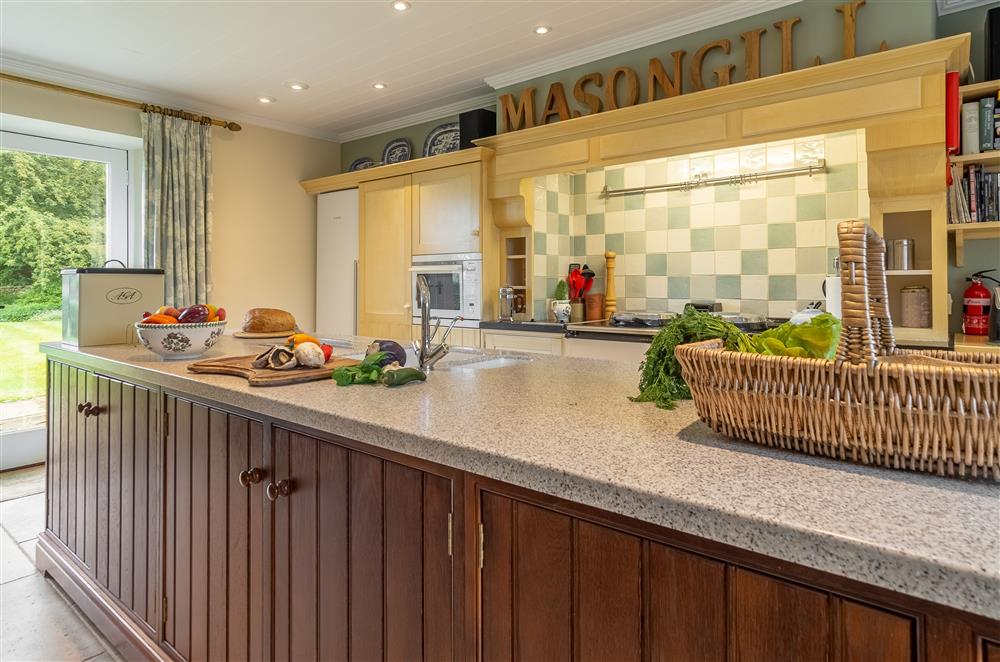 Kitchen with Aga and dining area with French doors to garden at Masongill Lodge, Masongill