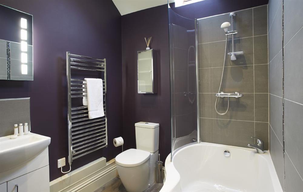 Bathroom with bath and shower over at Masons Cottage, Ampleforth