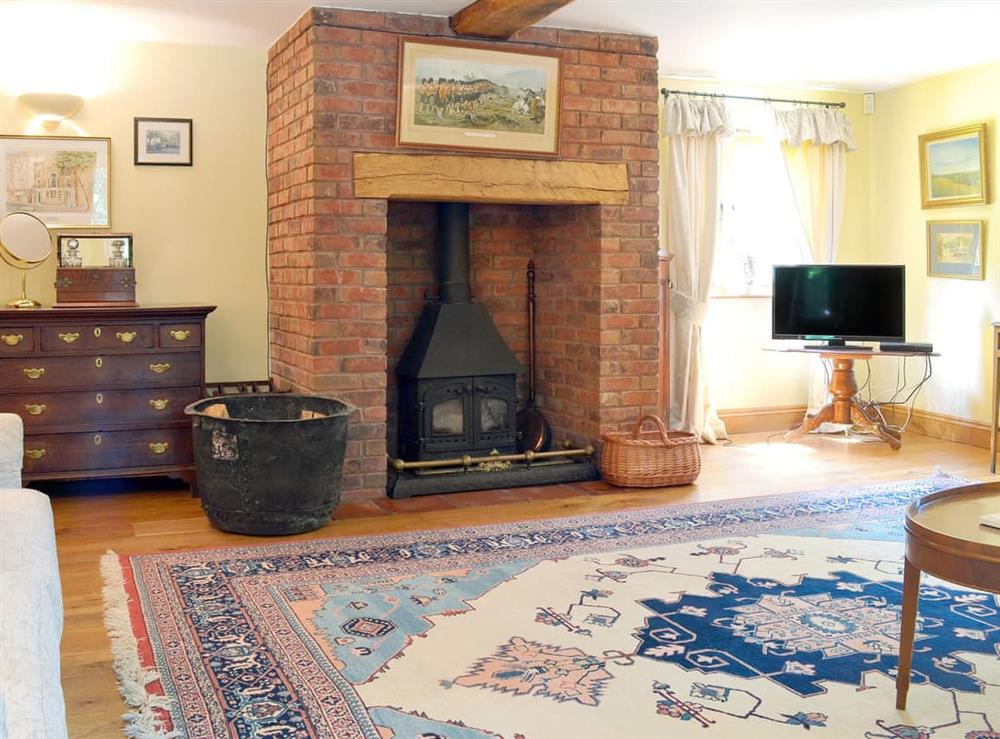Spacious living room with wood burner at Mill Farmhouse, 