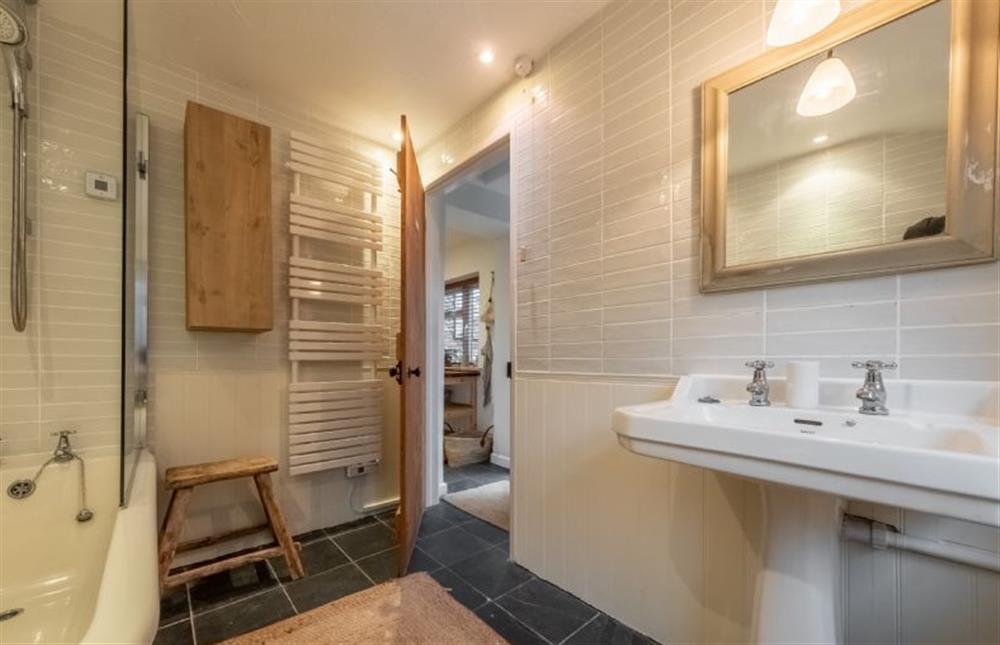 The bath has an overhead shower at Maurice Cottage, Docking near Kings Lynn