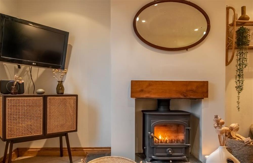 The sitting room with wall-mounted television at Maurice Cottage, Docking near Kings Lynn