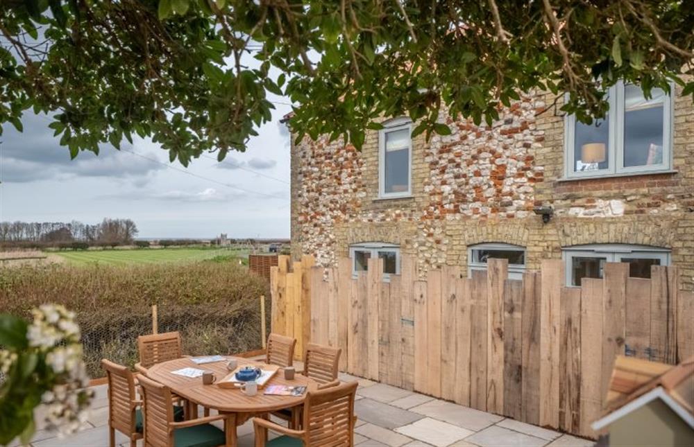 The outside dining area, with garden furniture seating up to six guests at May Cottage, Titchwell