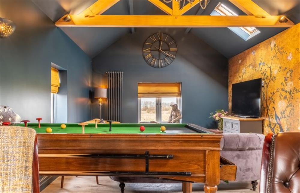The sitting room boasts exposed beams at May Cottage, Titchwell