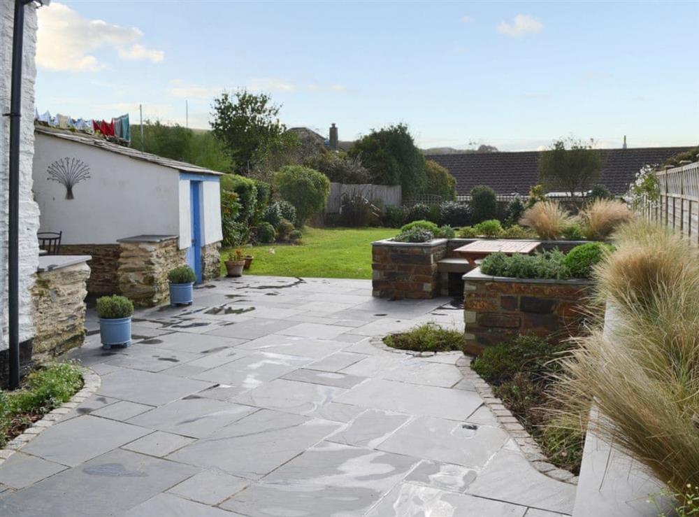 Beautifully tiled patio and lawned garden at May Cottage in Tywardreath, near Fowey, Cornwall