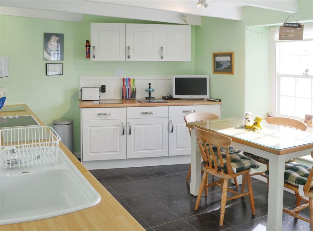 Light and airy kitchen/diner with tiled floor at May Cottage in Tywardreath, near Fowey, Cornwall