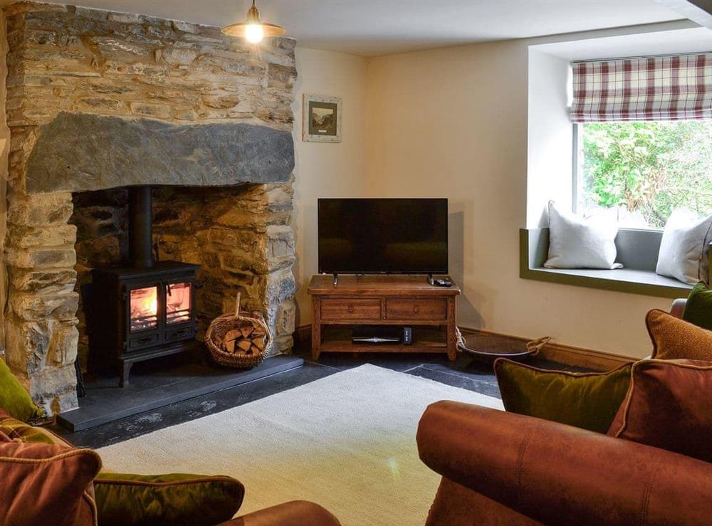 Cosy living room with wood burner & slate floor at Maybill Cottage in Cwm Penmachno, near Betws-y-Coed, Conwy, Gwynedd