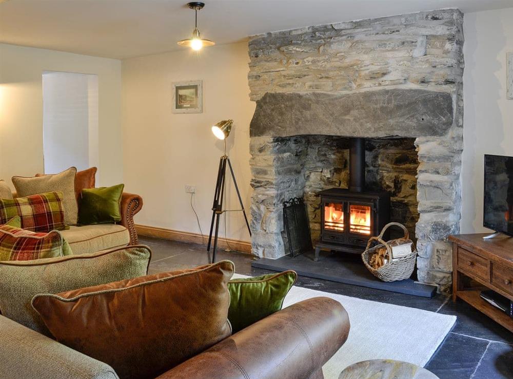 Cosy living room with Wood burning stove at Maybill Cottage in Cwm Penmachno, near Betws-y-Coed, Conwy, Gwynedd