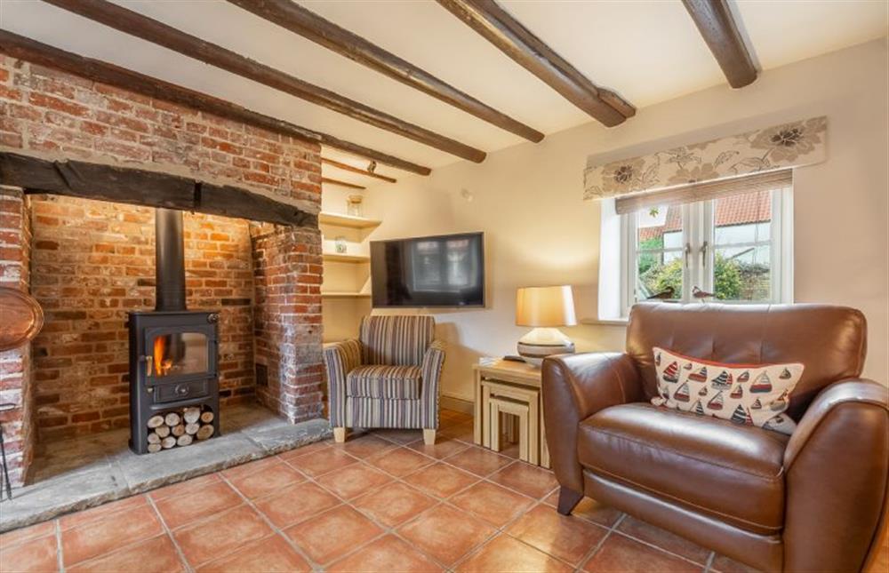 Ground floor: Sitting room with wood burning stove (photo 2) at Mayes Cottage, Brancaster near Kings Lynn