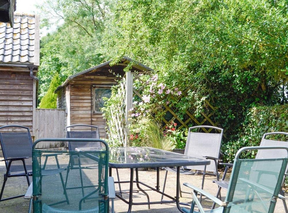 Patio area with outdoor furniture at Meadow Cottage in Linstead Parva, near Southwold, Suffolk