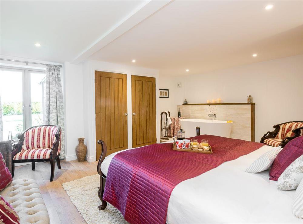 Large bedroom with free standing bath and en-suite at The Cart Lodge, 