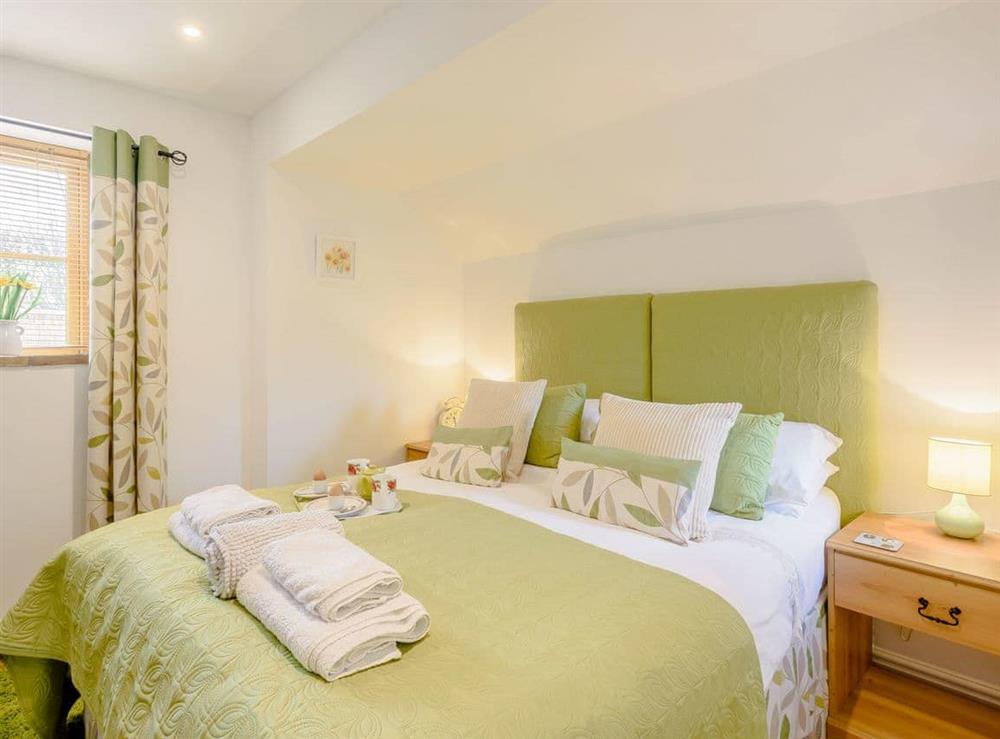 Comfortable bedroom with kingsized bed and en-suite shower room at The Hayloft, 