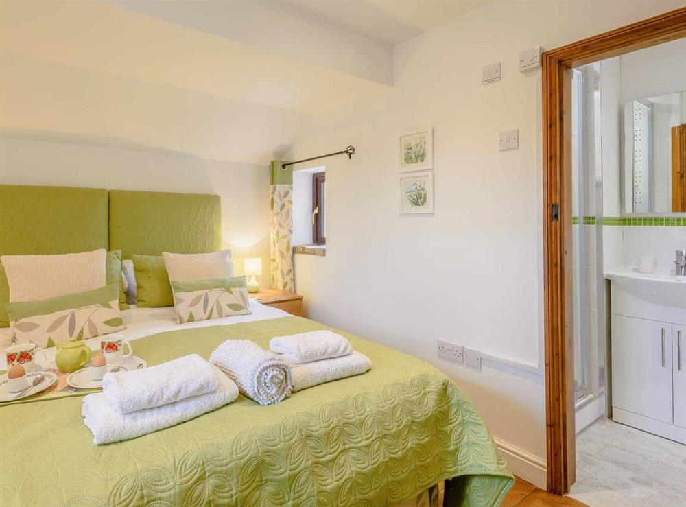 Comfy double bedroom with kingsized bed and en-suite shower room at The Hayloft, 
