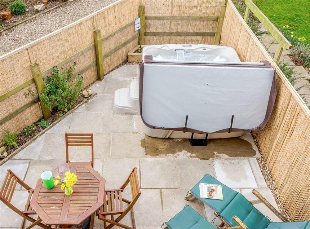 Lovely patio area with hot tub at The Hayloft, 