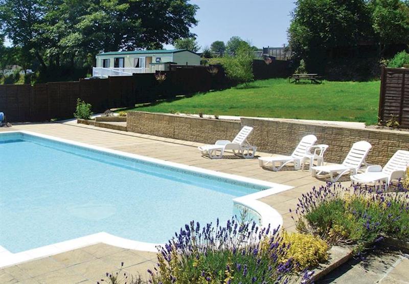 Outdoor heated swimming pool at Meadow Lakes Holiday Park in South Cornwall, South West of England