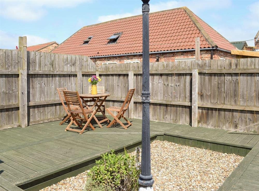 Decked area of garden with outdoor furniture at Meadow View in Brandesburton, Nr Bridlington, East Yorkshire., North Humberside