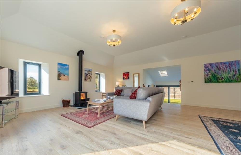 Ground floor: Large sitting room with five-seater corner sofa, armchairs and wood burning stove at Meadow View, Little Snoring near Fakenham