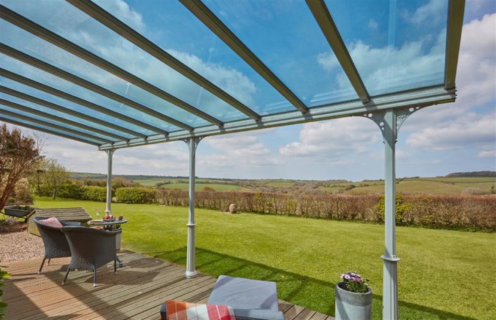 Enjoy the countryside views on the decked veranda at Meadow View, Newquay