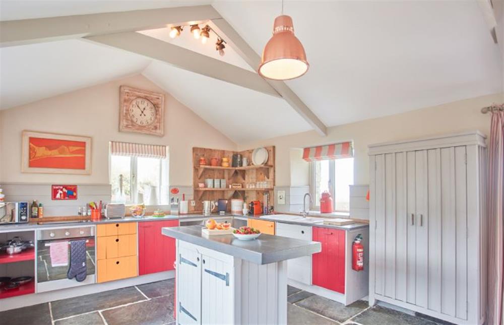 Meadow View, Newquay. Well-equipped kitchen and dining area with bespoke slate flooring, electric oven and hob, integrated fridge/freezer, dishwasher, washer/dryer and a dining table for two guests