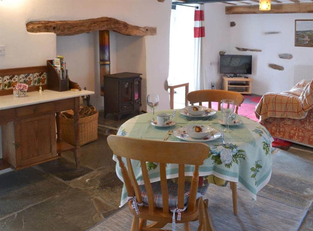 Flag-floored dining area with woodburner at Meadwell in Trebarwith, Delabole., Cornwall