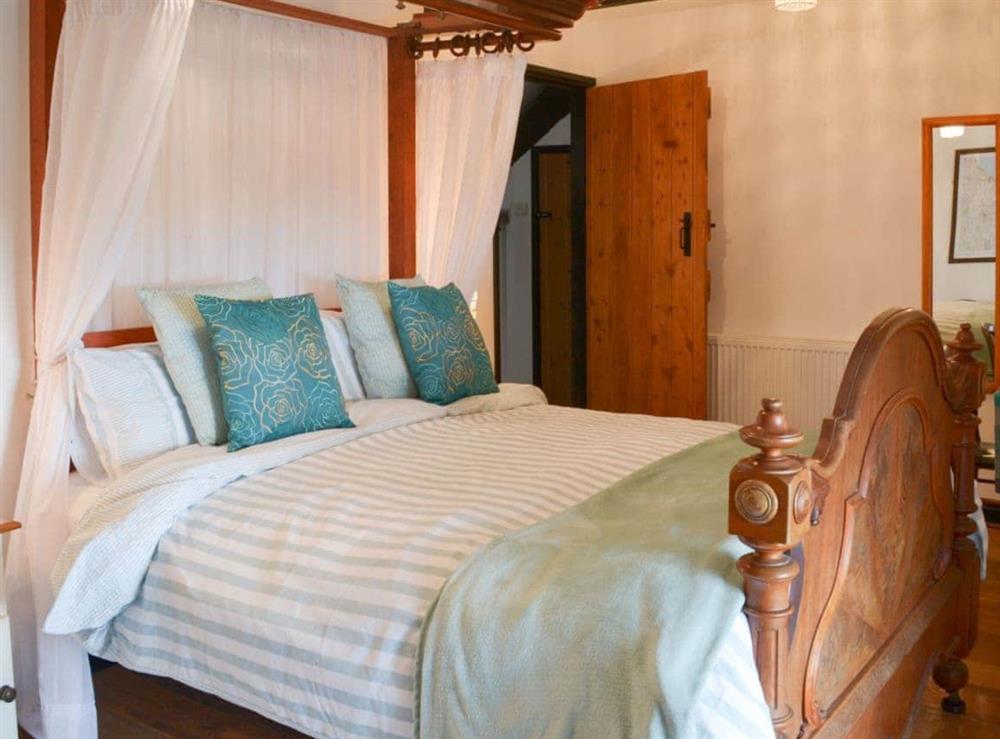 Romantic and inviting bedroom with canopy bed at Meadwell in Trebarwith, Delabole., Cornwall