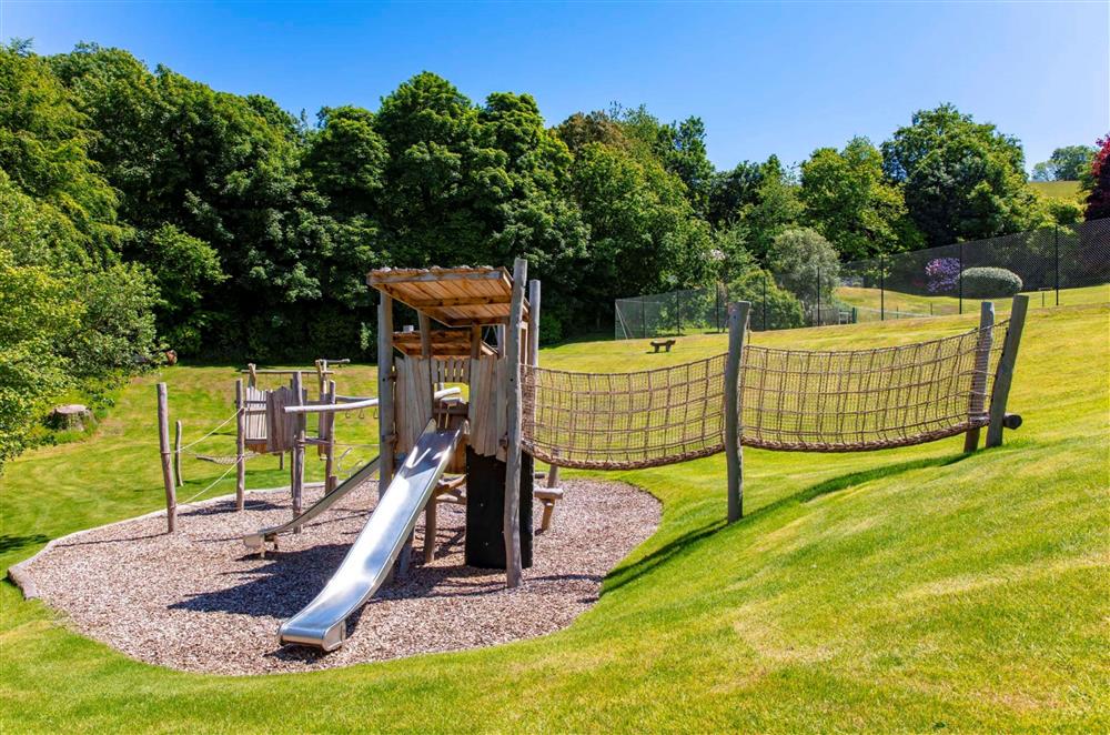 The children’s outdoor play ground with traditional wooden seats at Meavy Cottage, Dartmouth
