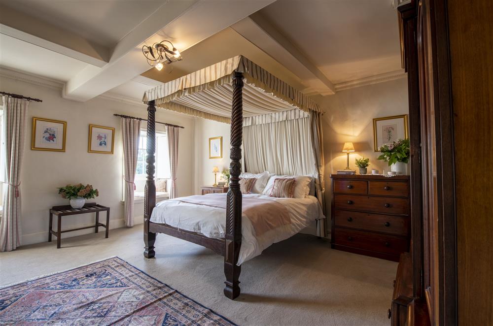 Exquisite Victorian bedroom on the second floor with a 5’ antique four poster bed and en-suite bathroom