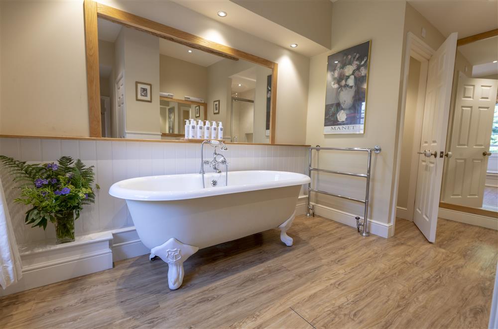 Master bedroom’s en-suite bathroom with a cast iron roll-top bath and separate walk-in shower at Melmerby Hall and Stag Cottage, Melmerby, near Langwathby, Penrith
