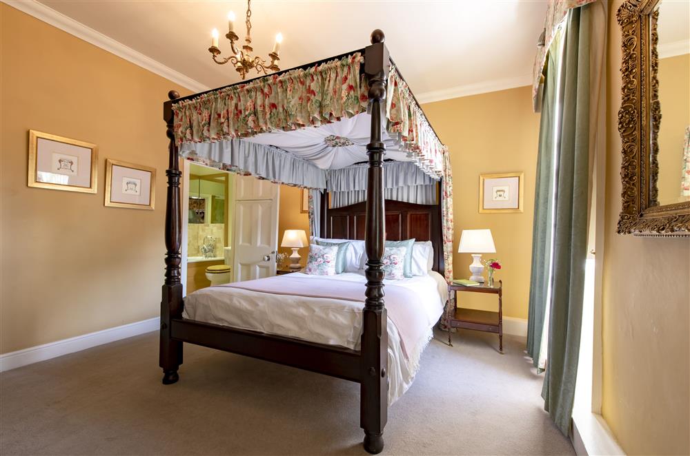 Regency room on the first floor with a 5’ antique canopied four-poster bed and en-suite bathroom