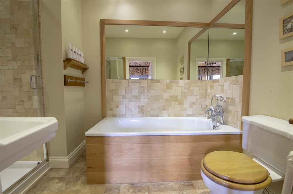 Regency room’s en-suite bathroom with a bath and handheld shower and separate walk-in shower at Melmerby Hall and Stag Cottage, Melmerby, near Langwathby, Penrith