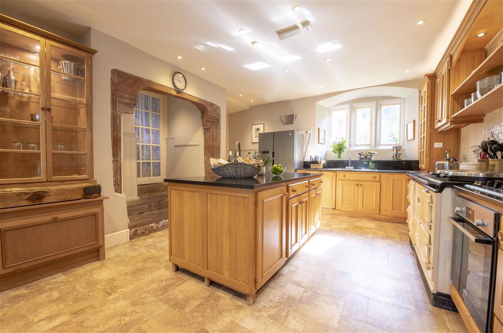 Spacious kitchen with central island and Aga leading to the Orangery at Melmerby Hall and Stag Cottage, Melmerby, near Langwathby, Penrith